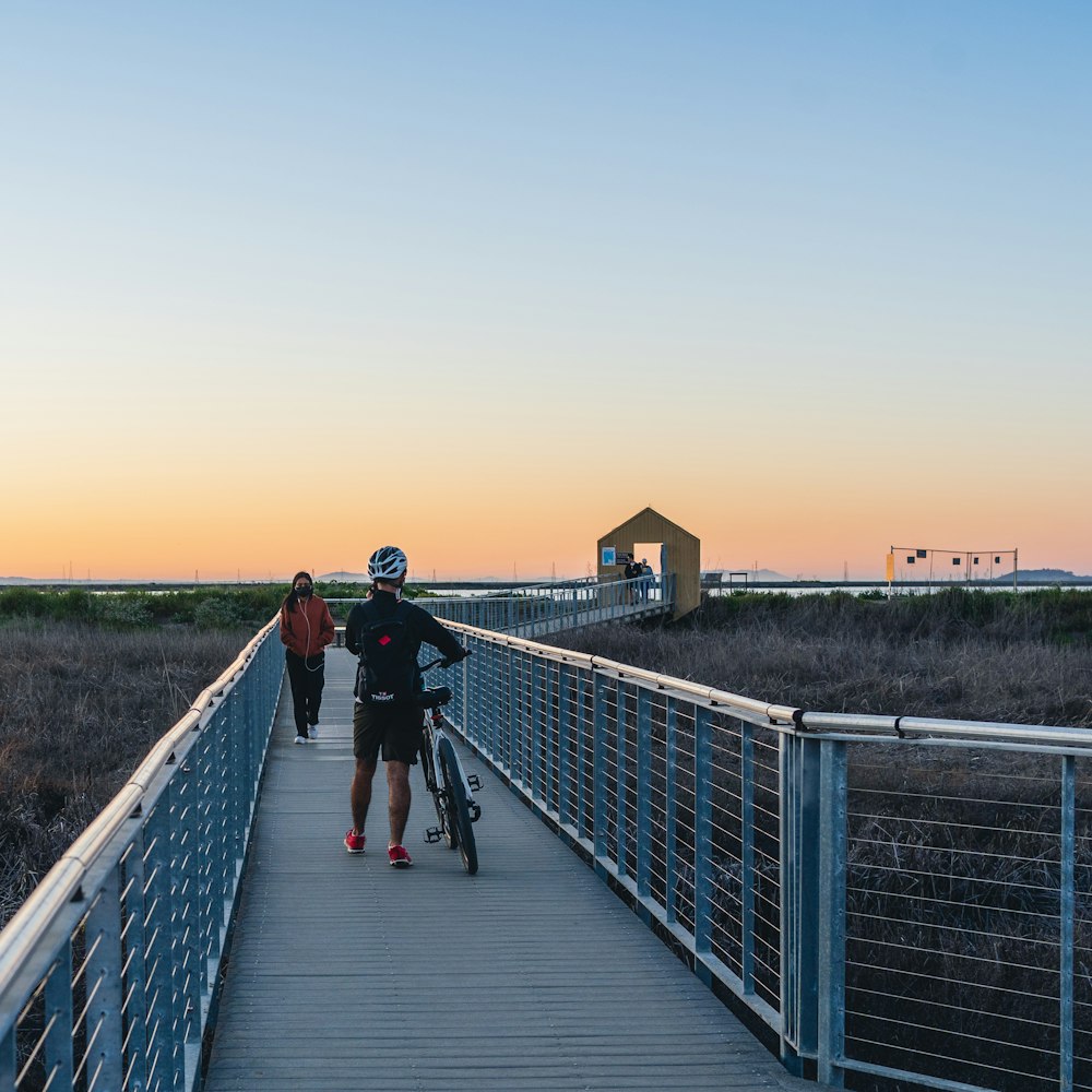 a group of people walking on a bridge