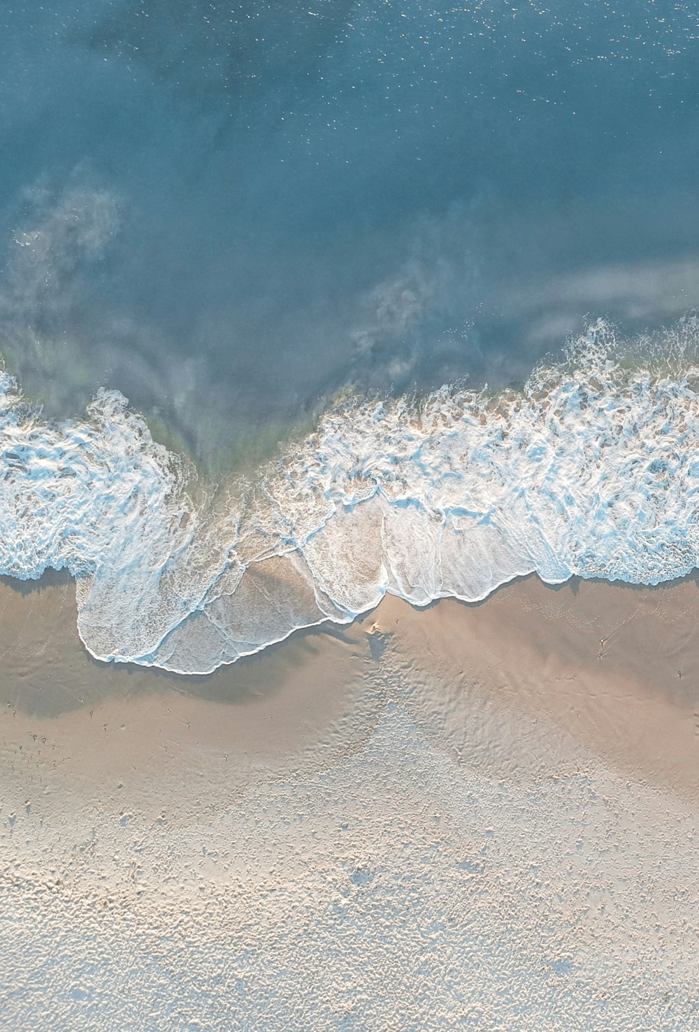 a wave crashing on a beach