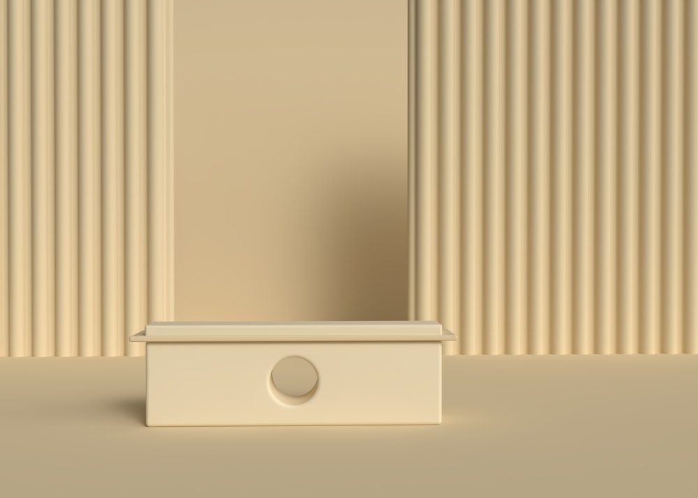 a white rectangular object with a round white object on top