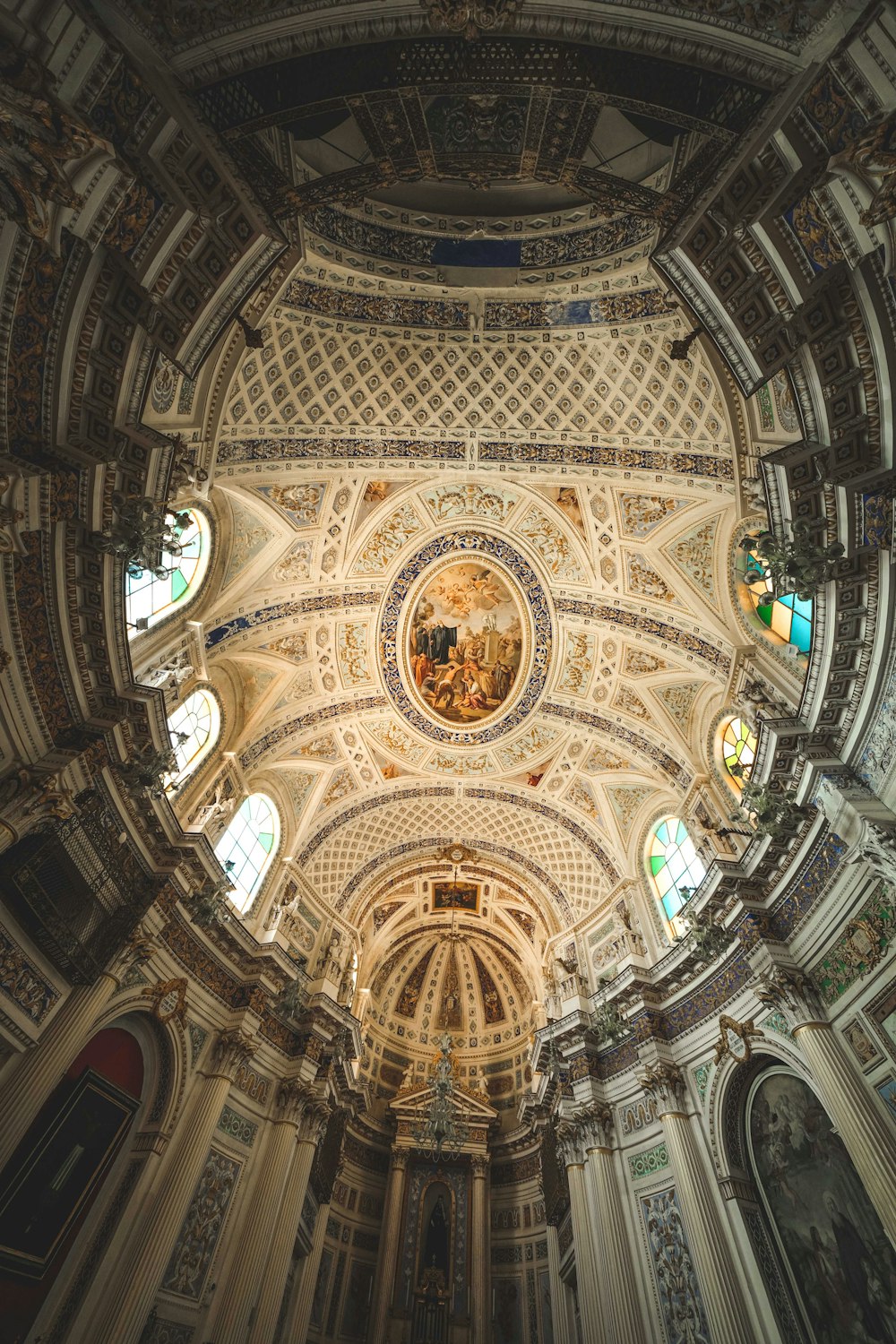 a large ornate ceiling with stained glass windows