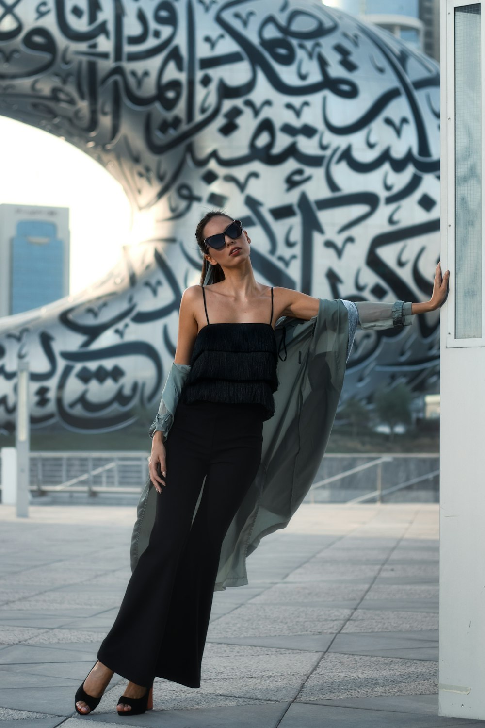 a person posing in front of a wall with graffiti