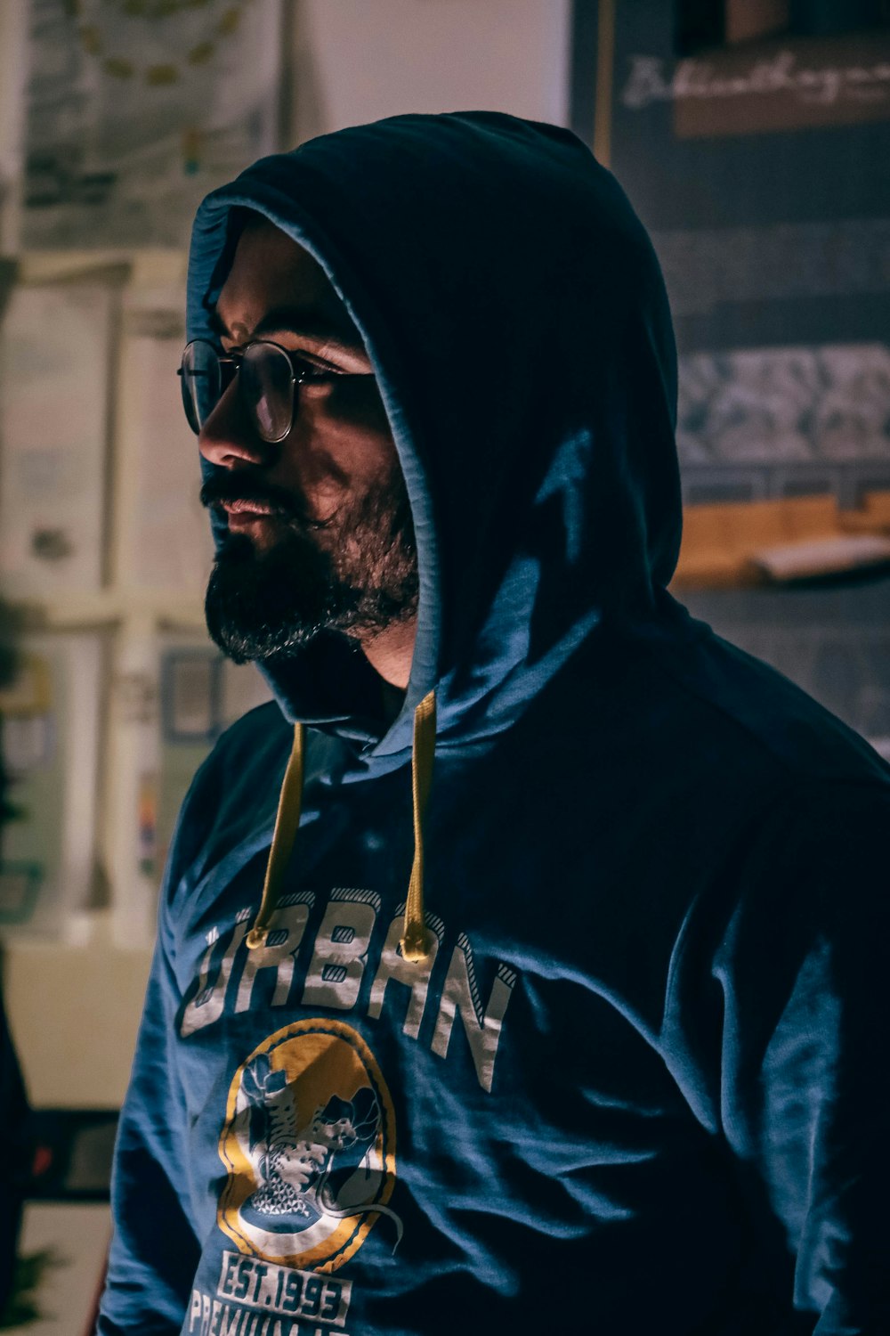 a man wearing a hoodie and sunglasses