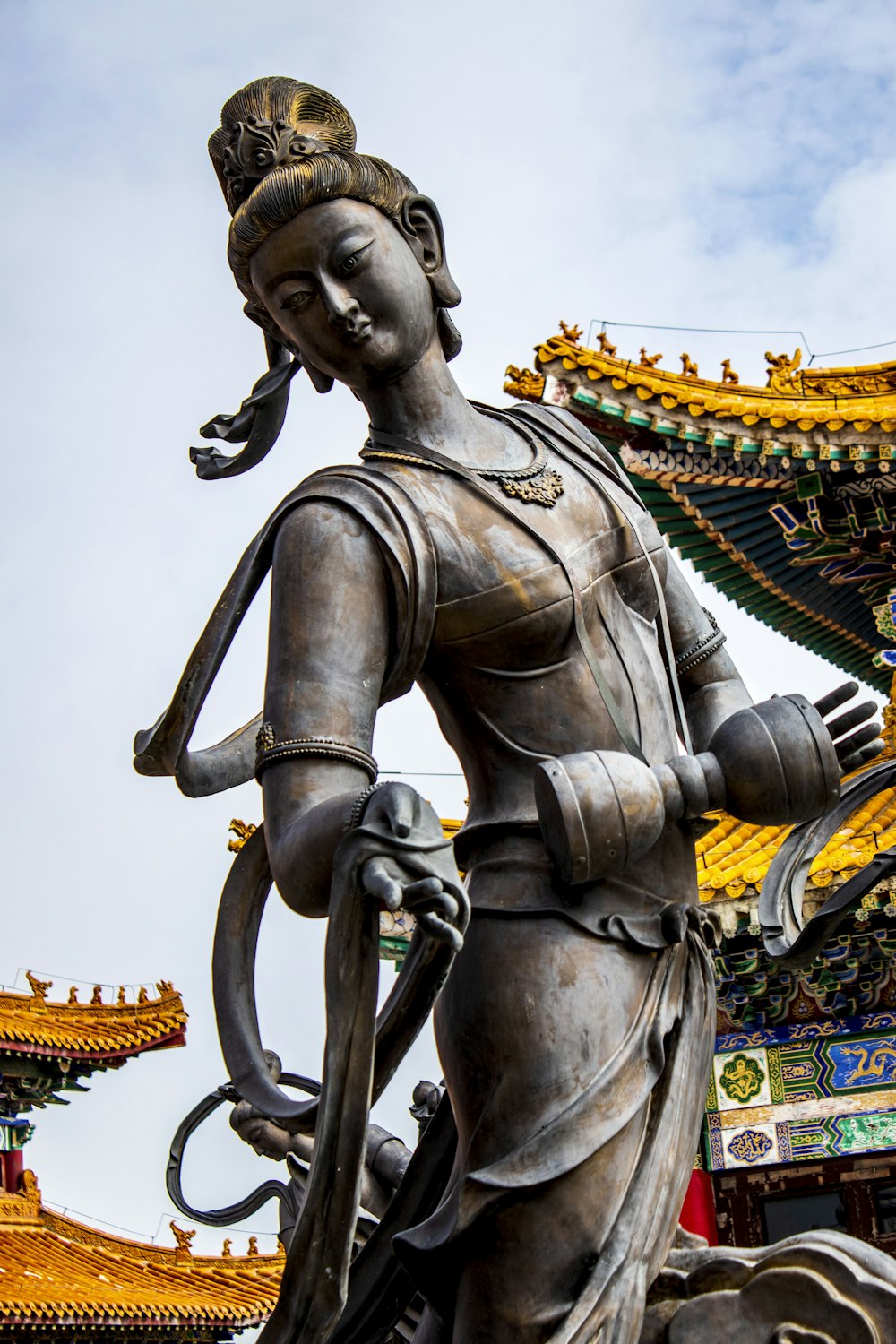 a statue of a person holding a sword