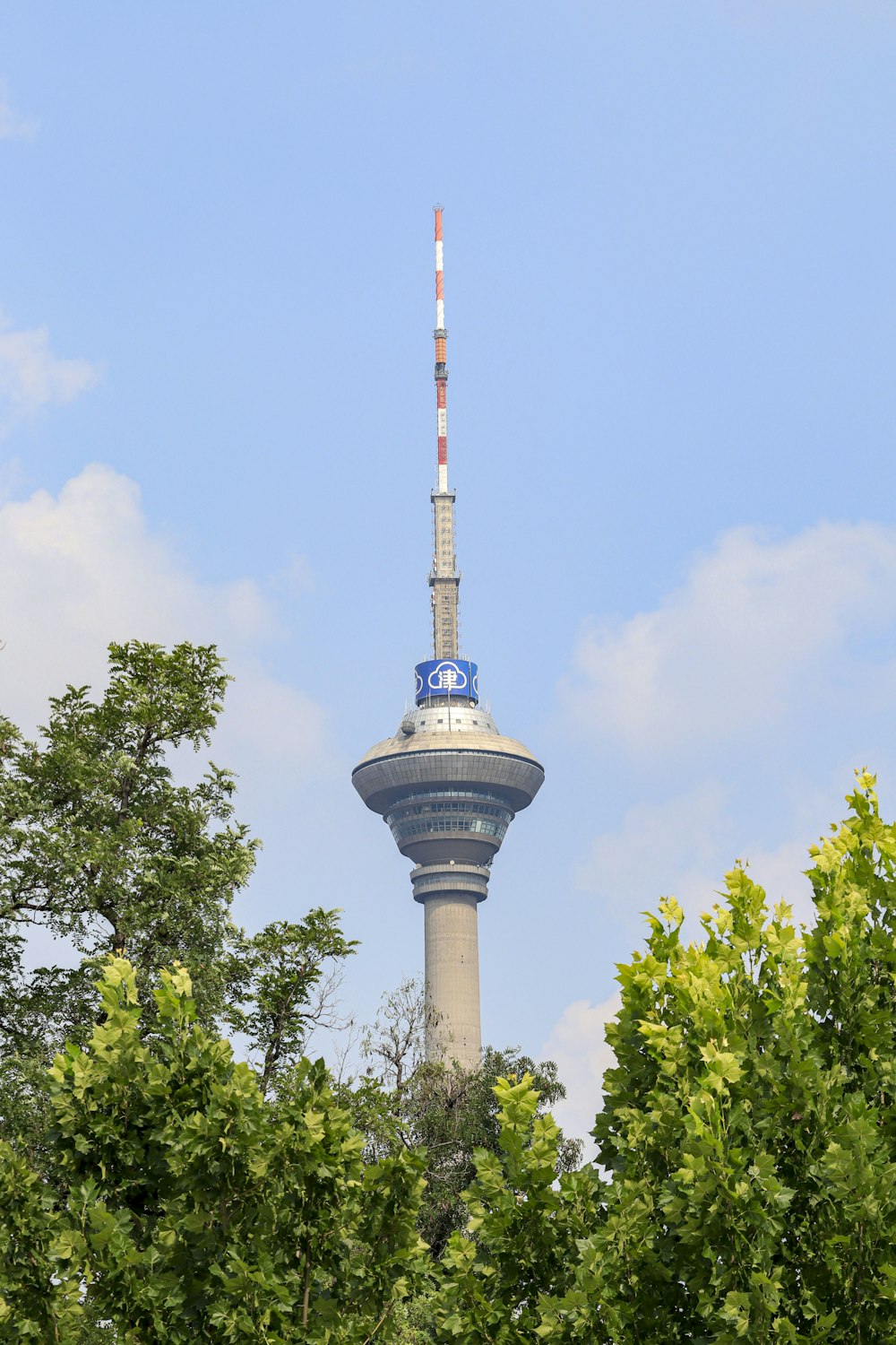 a tall tower with trees around it