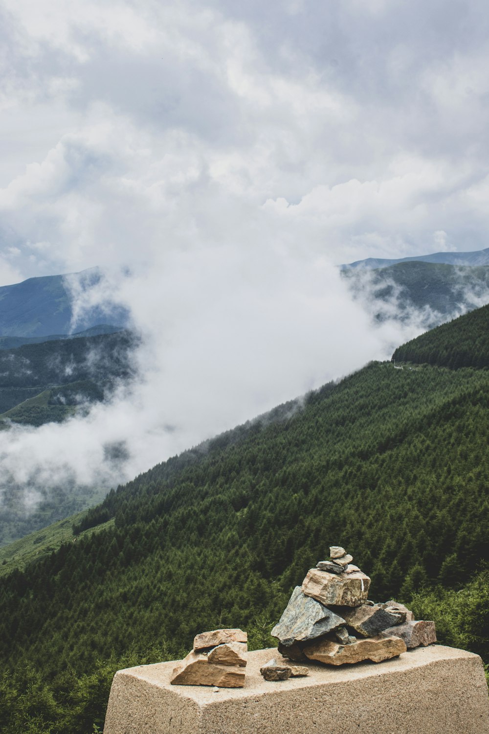 a stone wall with a mountain in the background