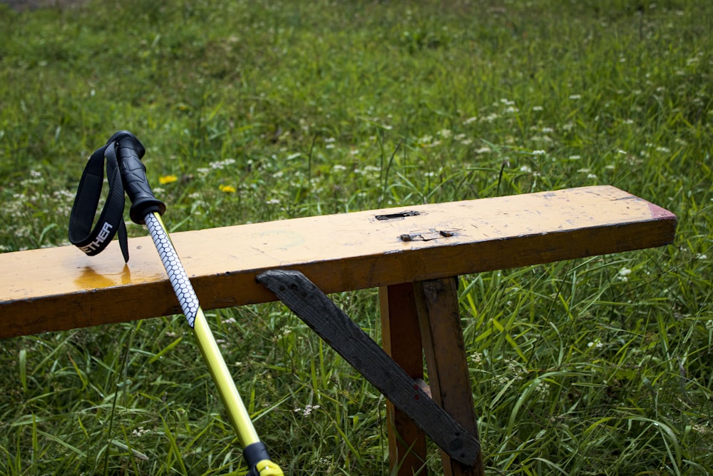 a wood bench with a pair of gloves on it