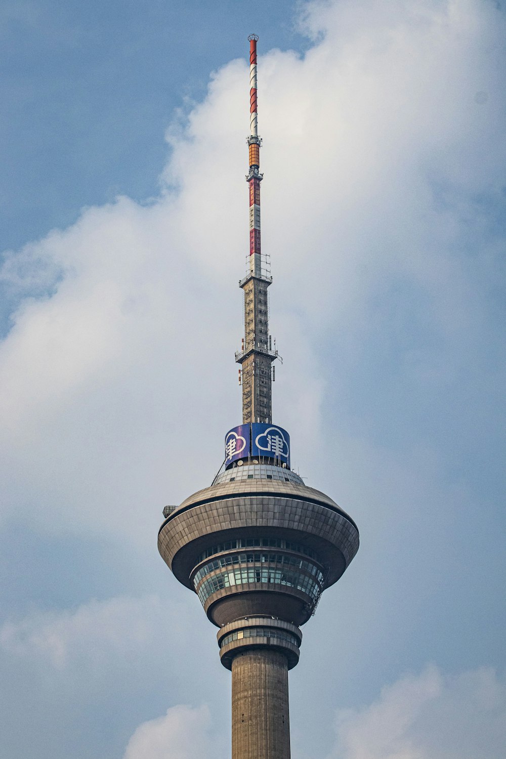 a tall tower with a blue and white sign on it