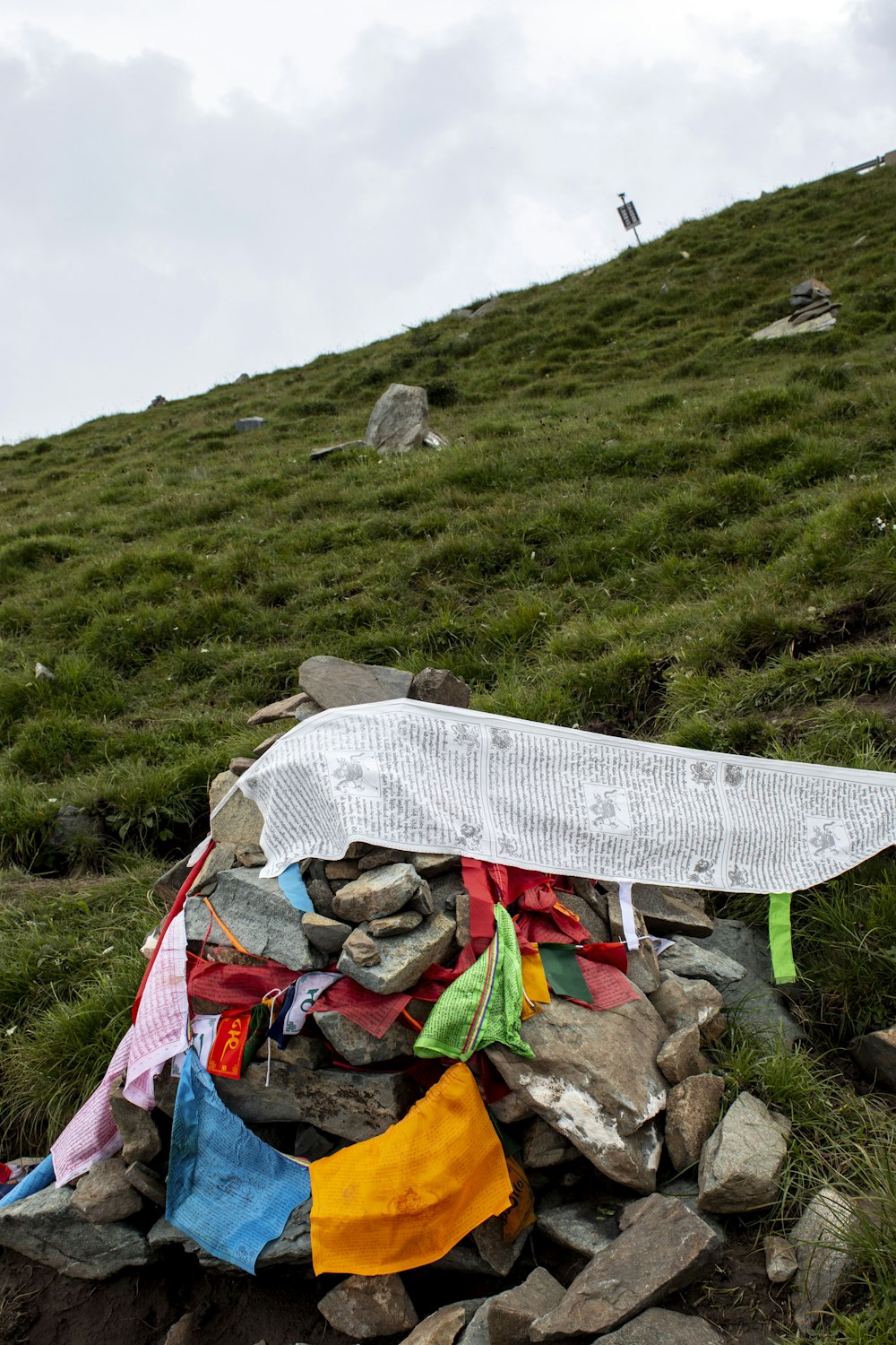 a pile of clothes on a grassy hill