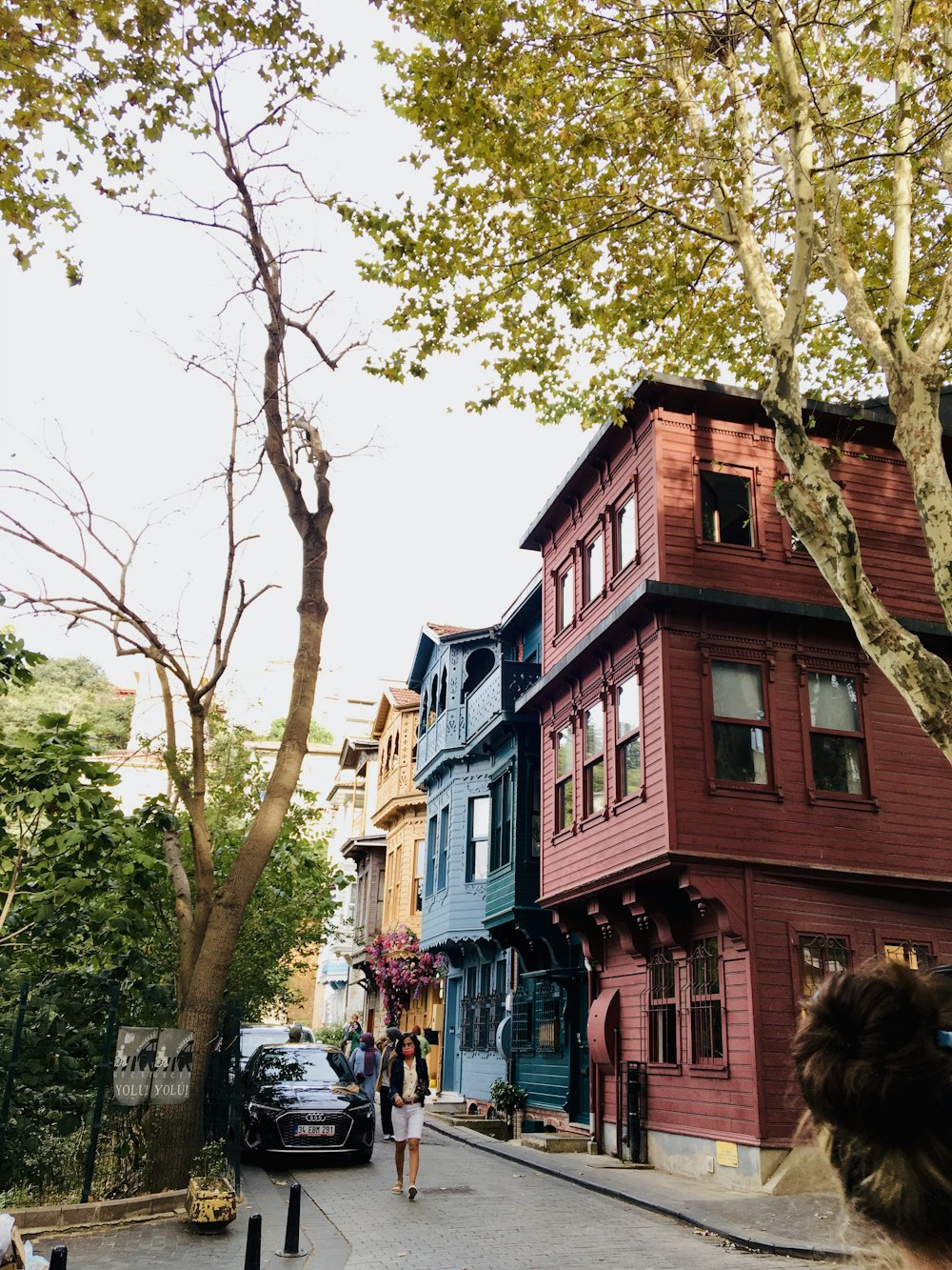 a street with trees and buildings on the side