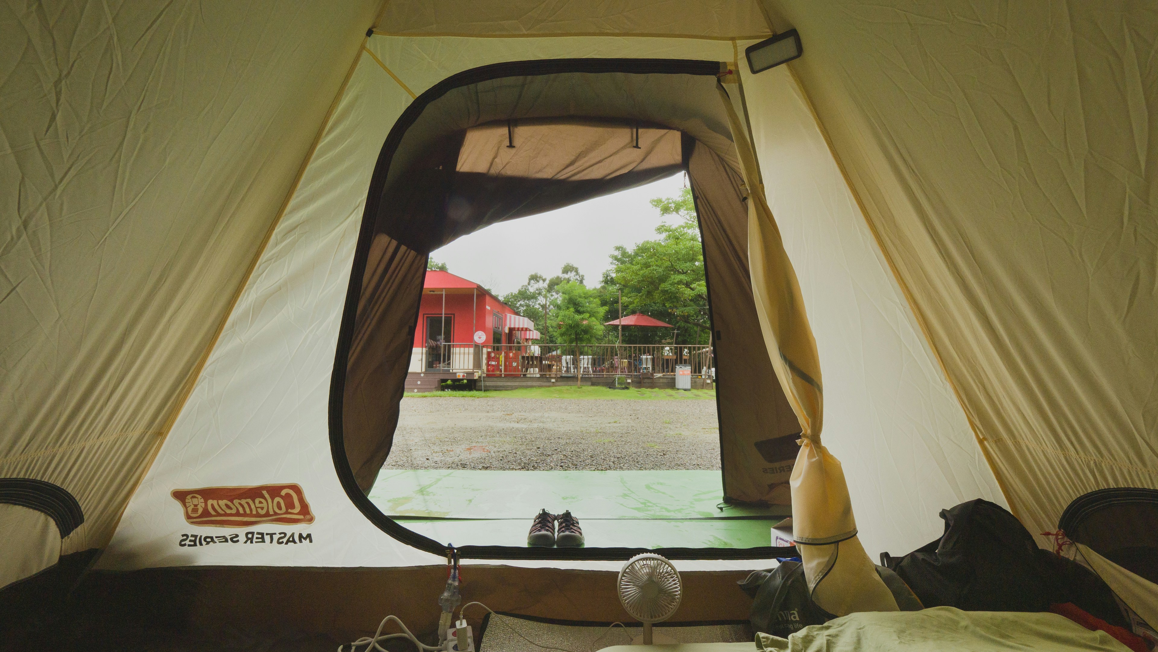 a tent with a view of a field and buildings