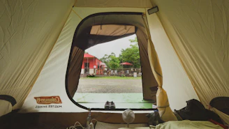 a tent with a view of a field and buildings