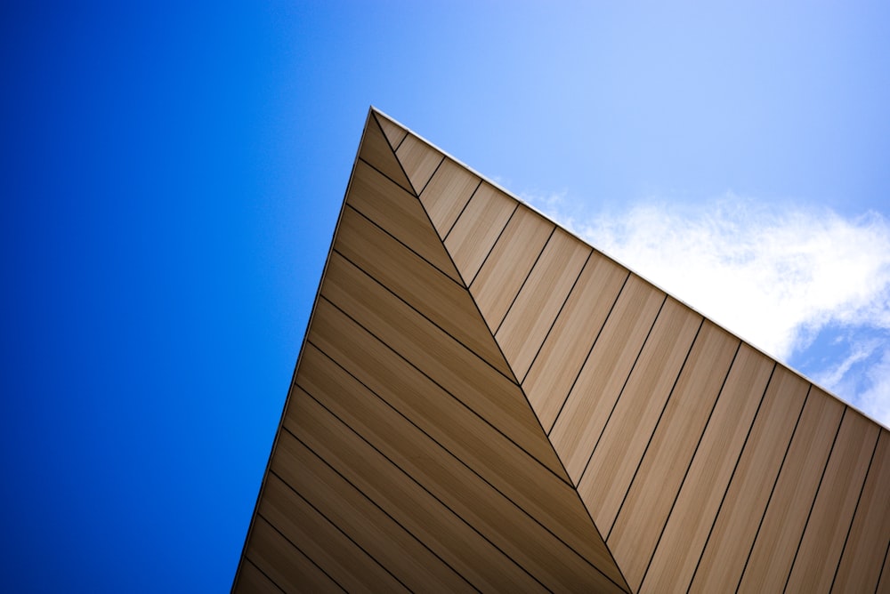 a wooden building with a blue sky with Eli and Edythe Broad Art Museum in the background