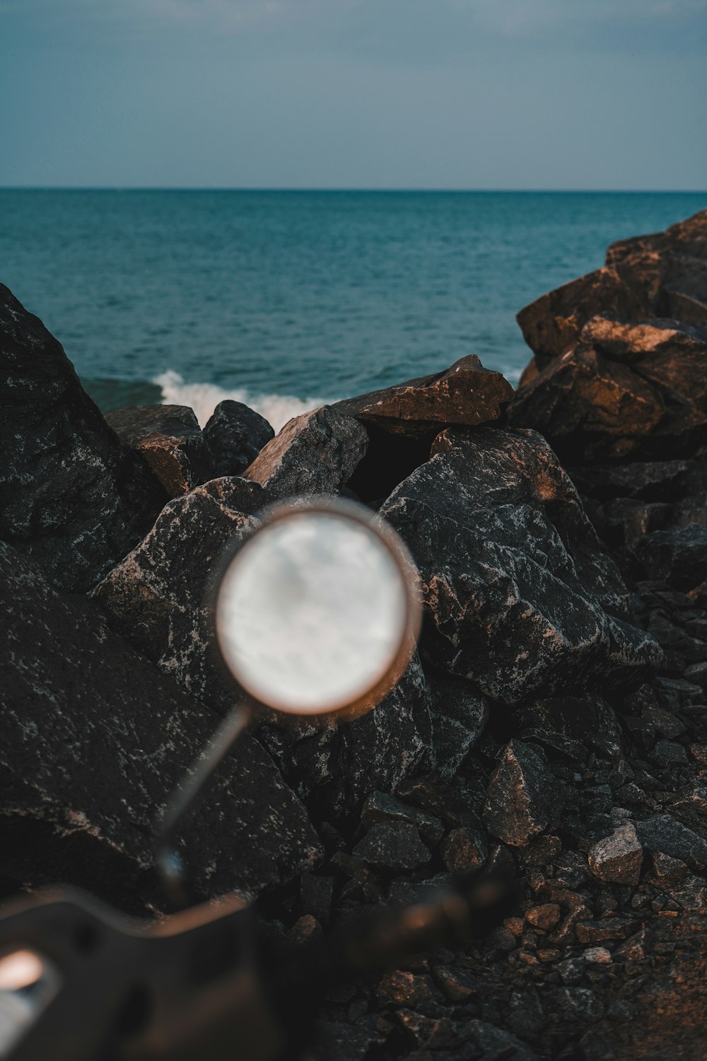 a metal object on a rocky beach