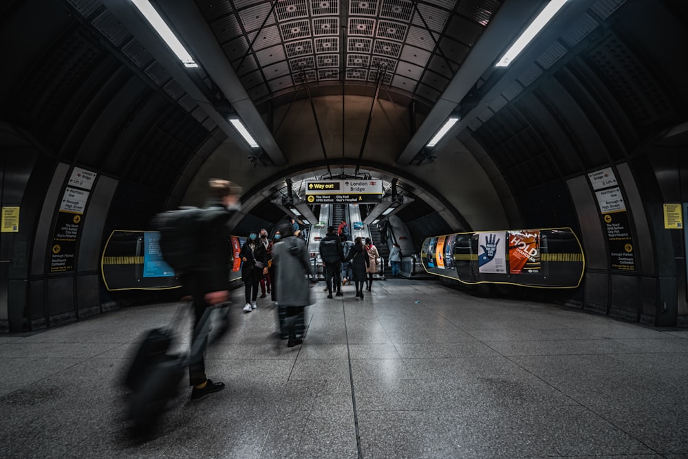 people walking in a train station