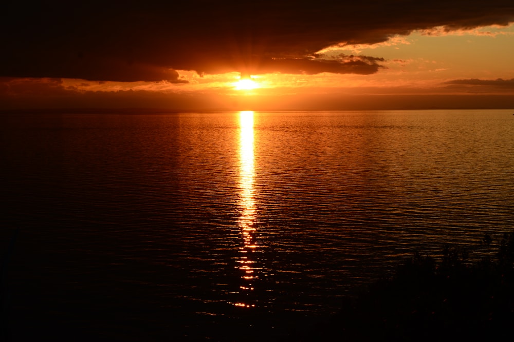 a sunset over a body of water