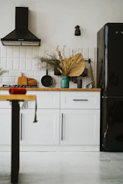 a kitchen with a black refrigerator