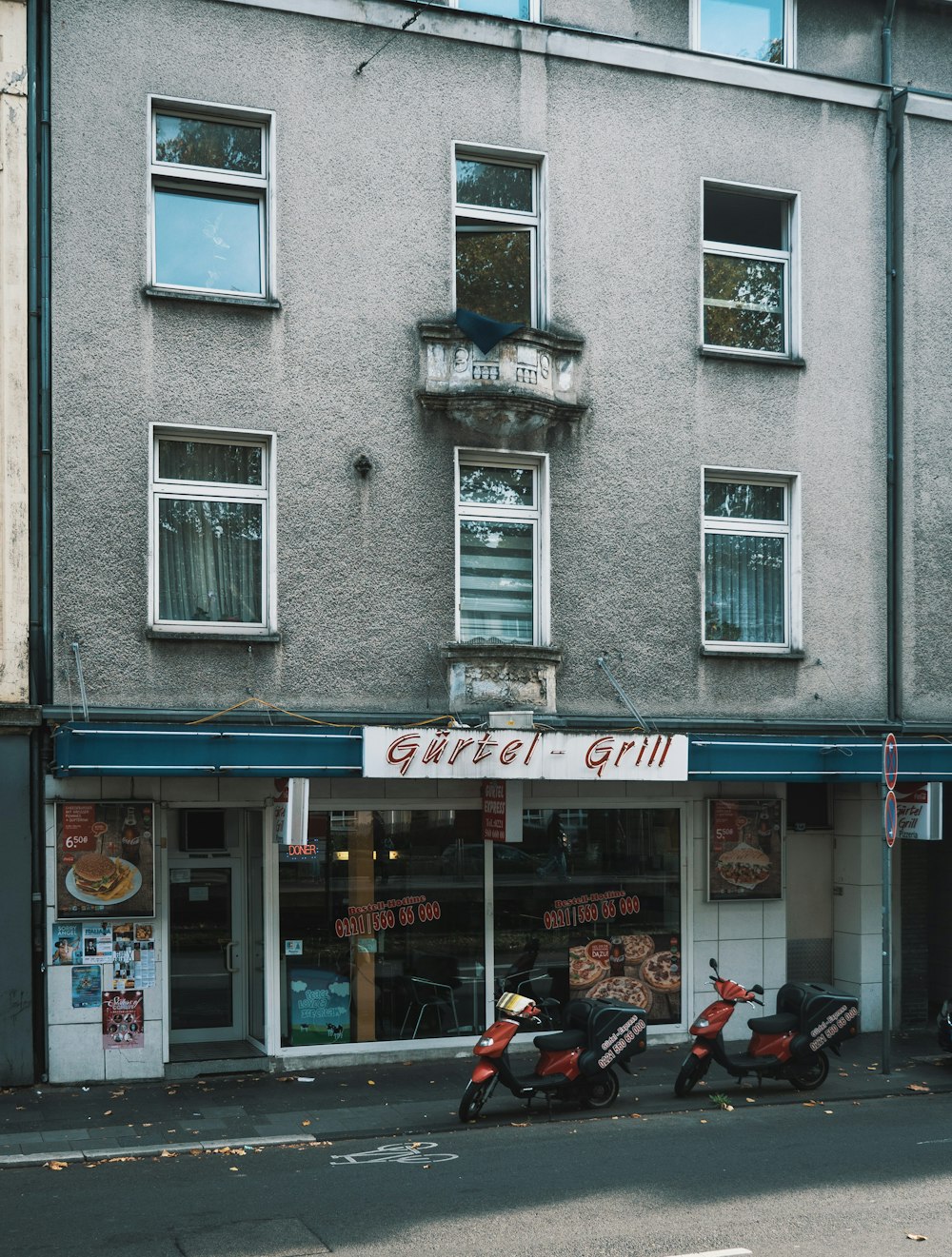 a store front with scooters parked in front