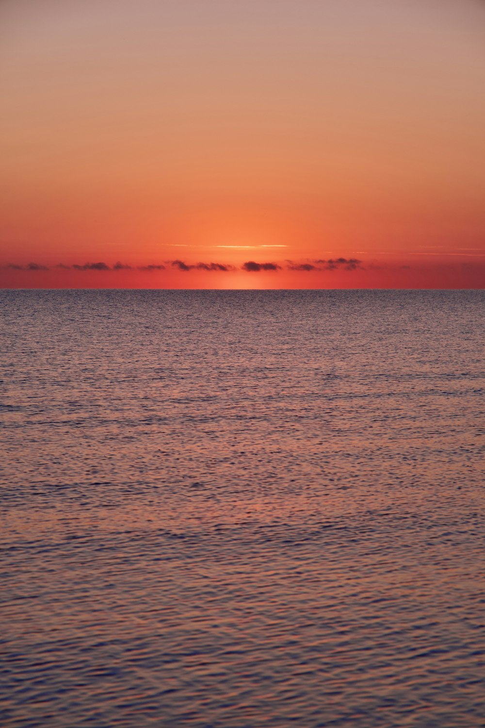 a body of water with a sunset