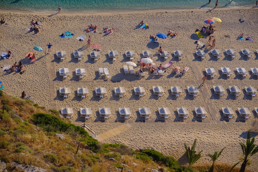 a beach with many chairs and umbrellas