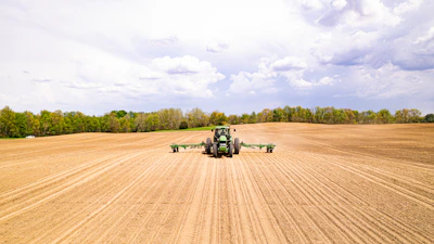 a tractor driving on a dirt road