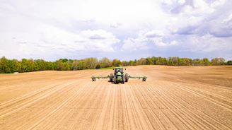 a tractor driving on a dirt road