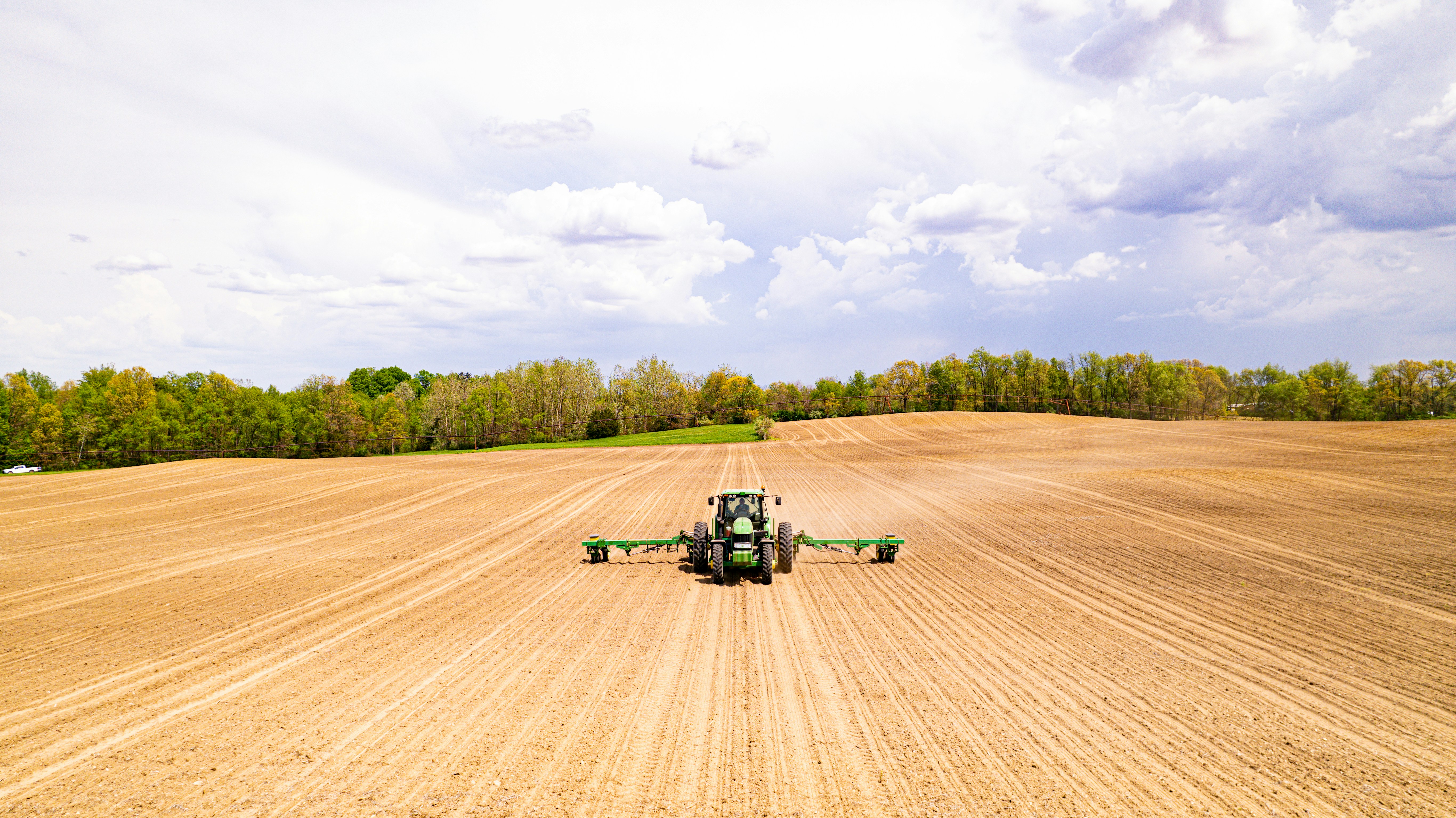 a tractor driving on a dirt road