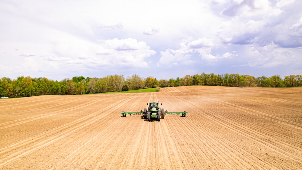 a tractor driving on a dirt road