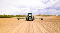 a tractor driving on a dirt road