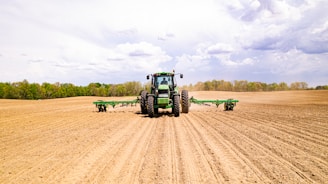 a tractor driving on a dirt road