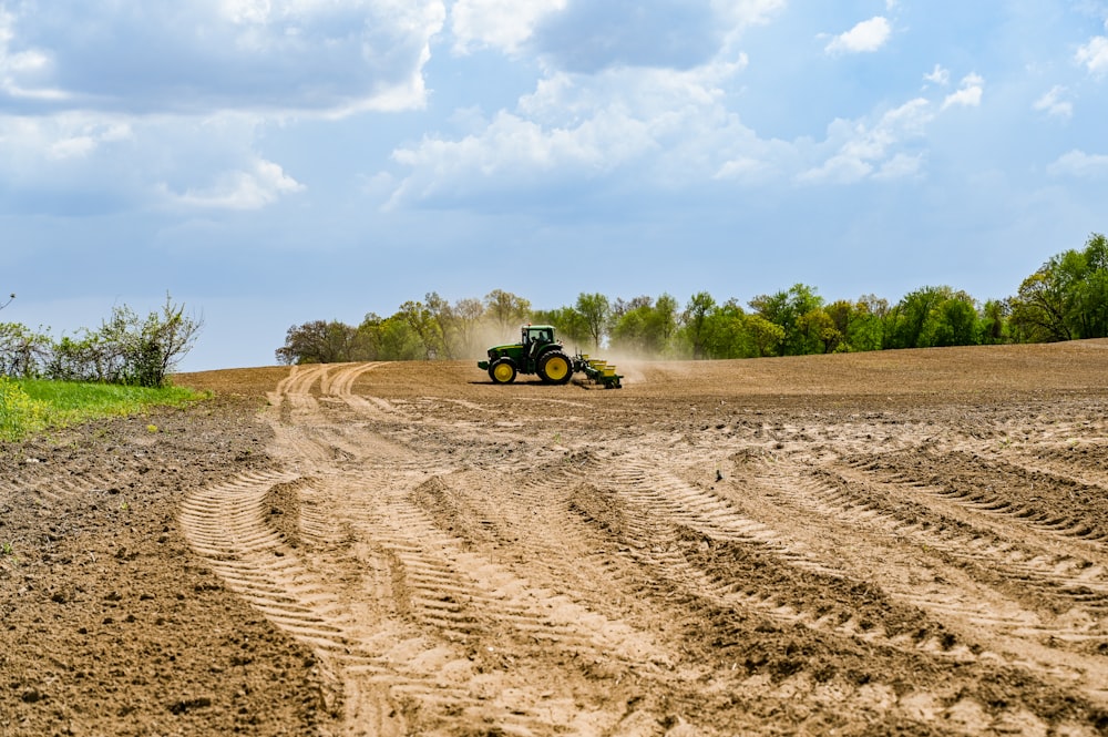 a tractor driving on a dirt road