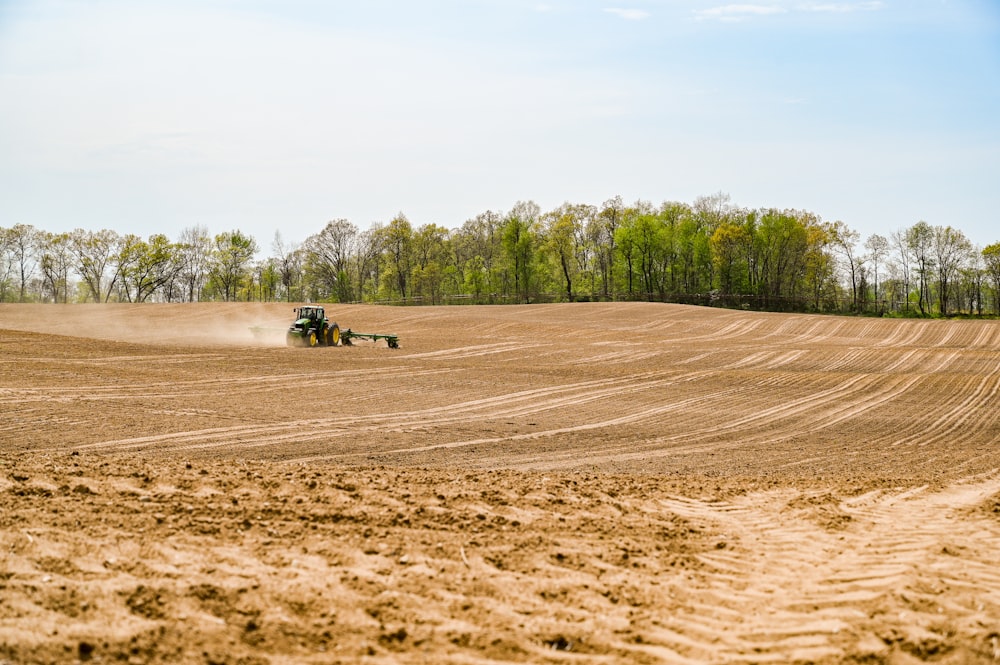 a couple of people riding on a machine in a field