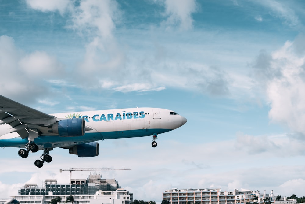 a large airplane flying over a city