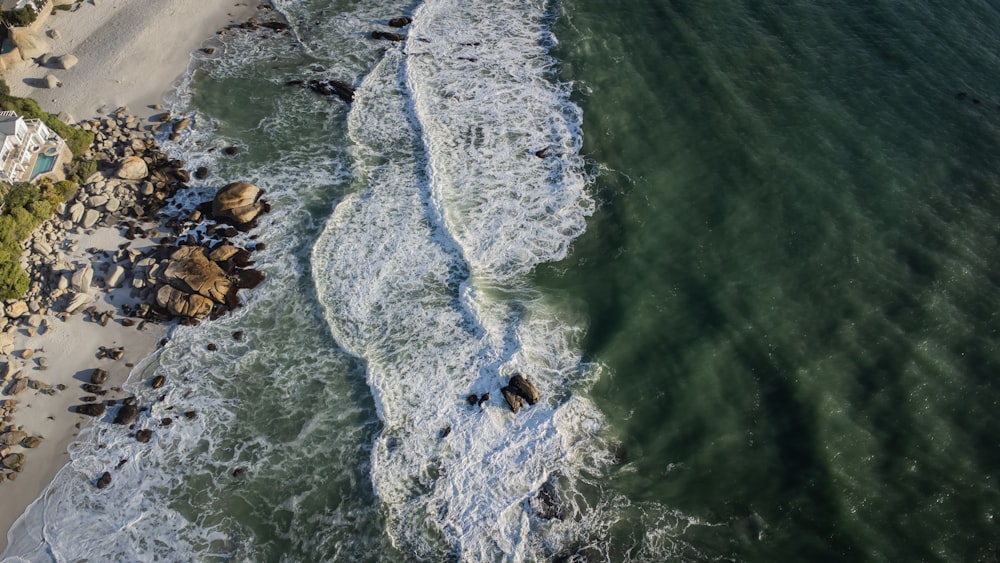 a body of water with rocks and a beach