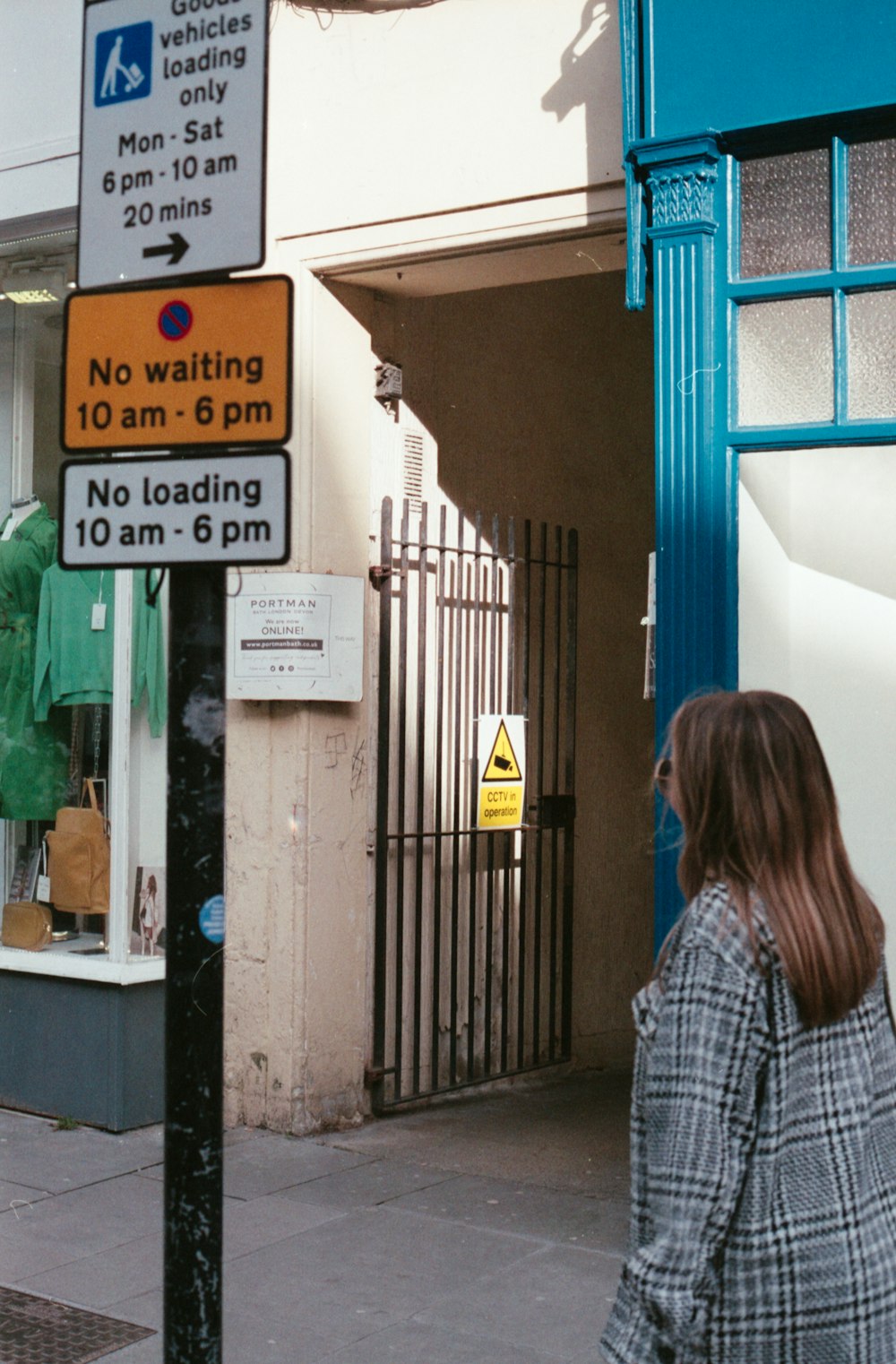 a woman standing next to a gate