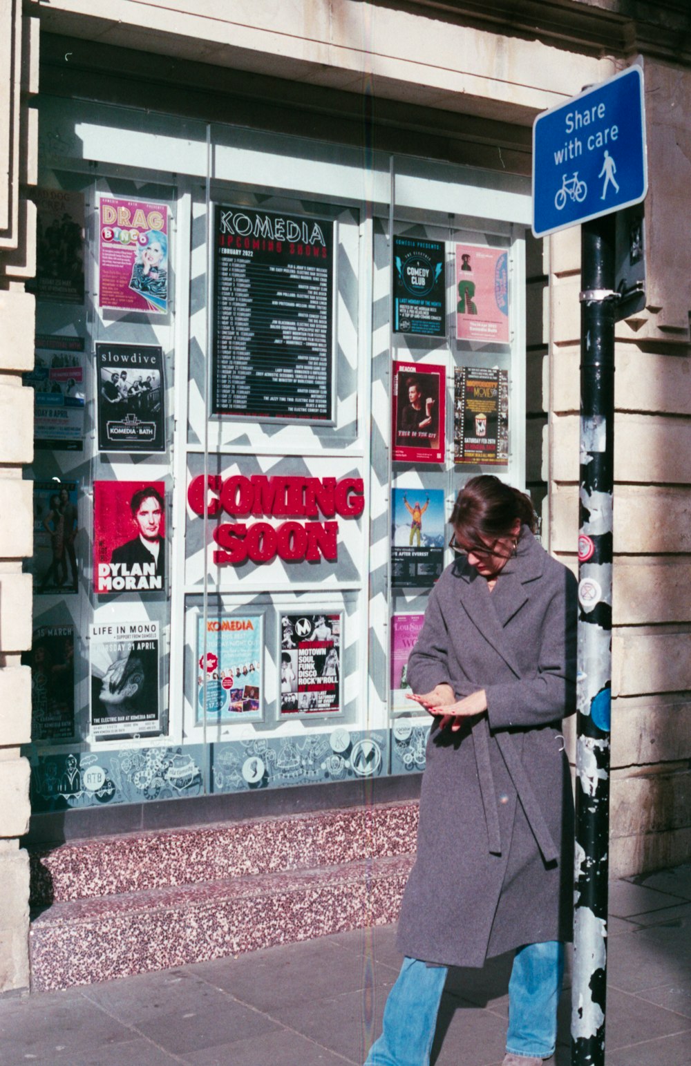 a person standing next to a sign