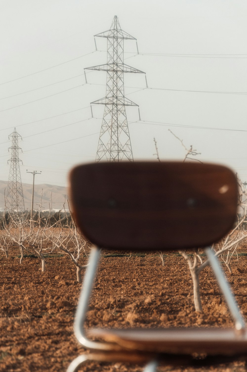 a black pot with a black lid and a metal pole in the background