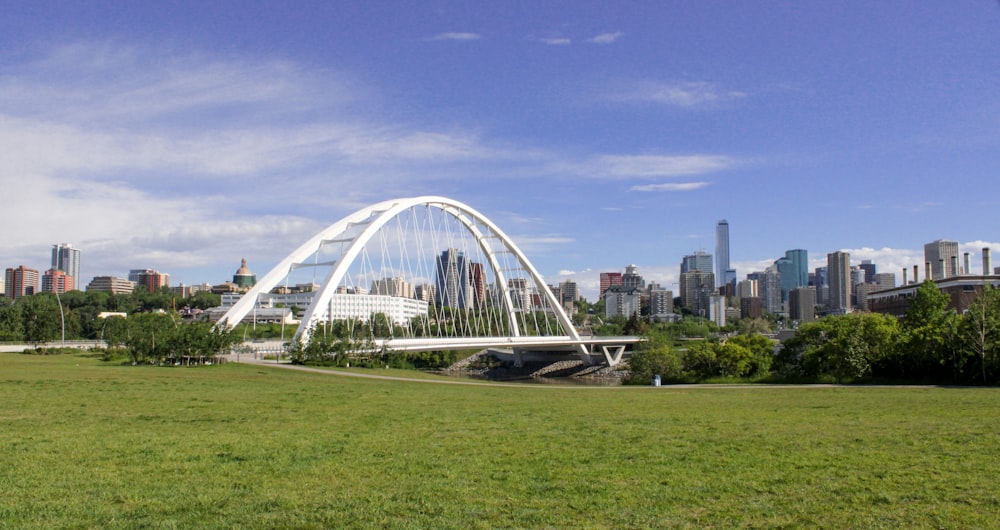 a large glass building with a city in the background