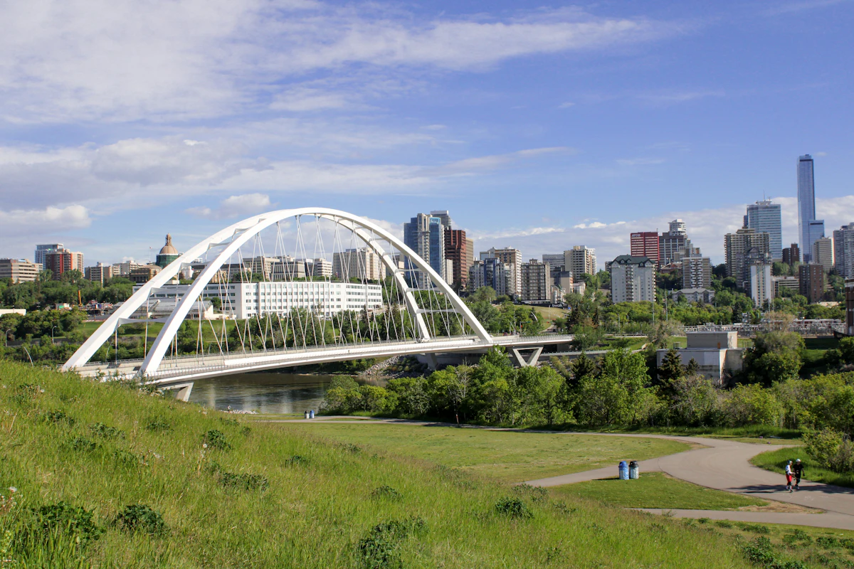 A bridge over the river with downtown Edmonton behind it