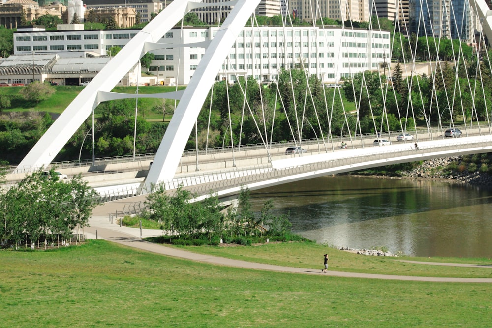 a large white building with a bridge over a river