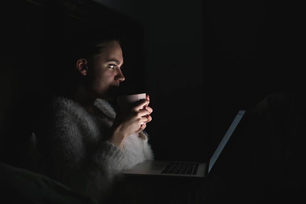 a person sitting in front of a laptop