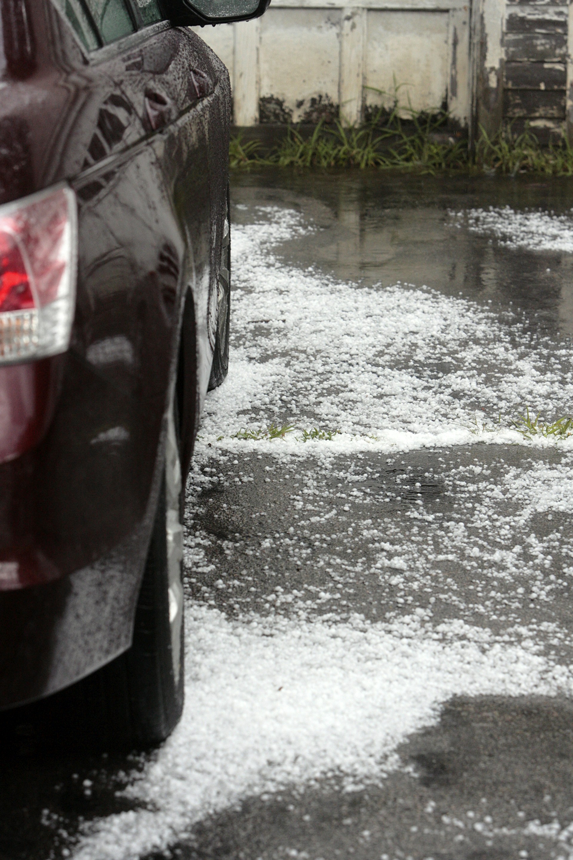 a car on a road with water on the side