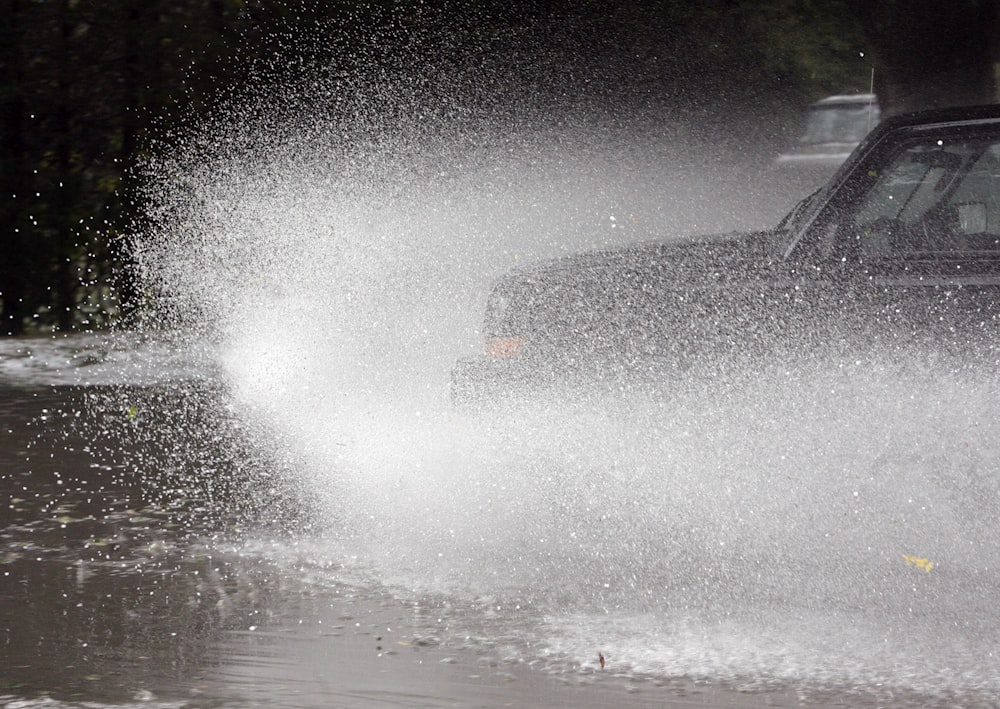 a car driving through a puddle