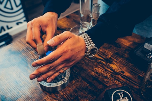 Close-up of hands analyzing product samples on a table