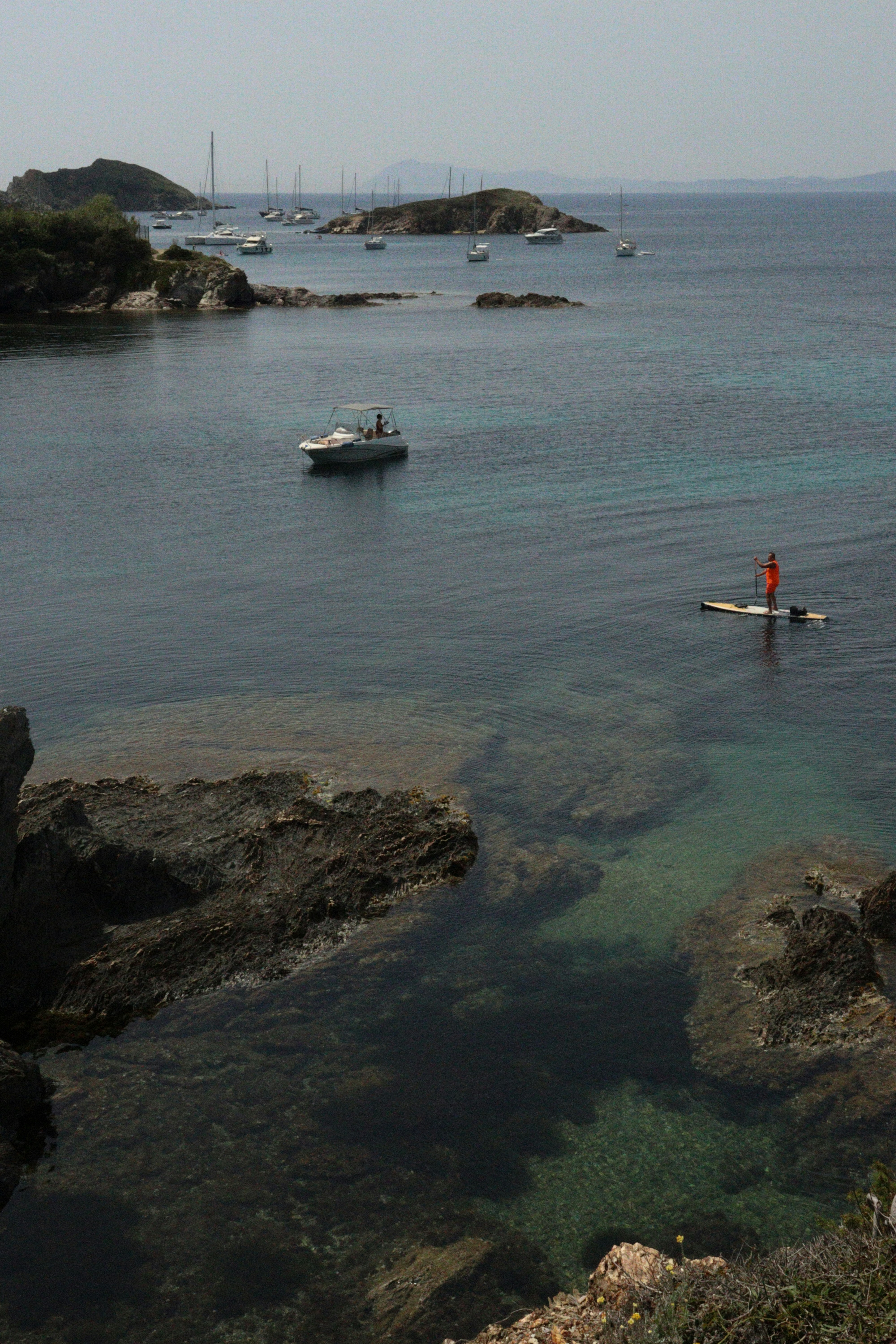 a person standing on a surfboard in the water