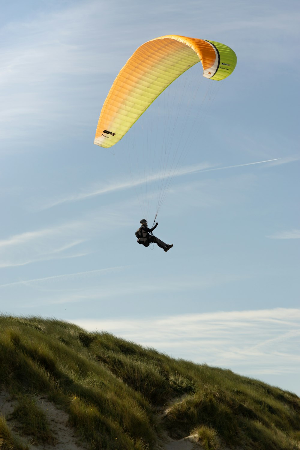 a person in the air with a parachute