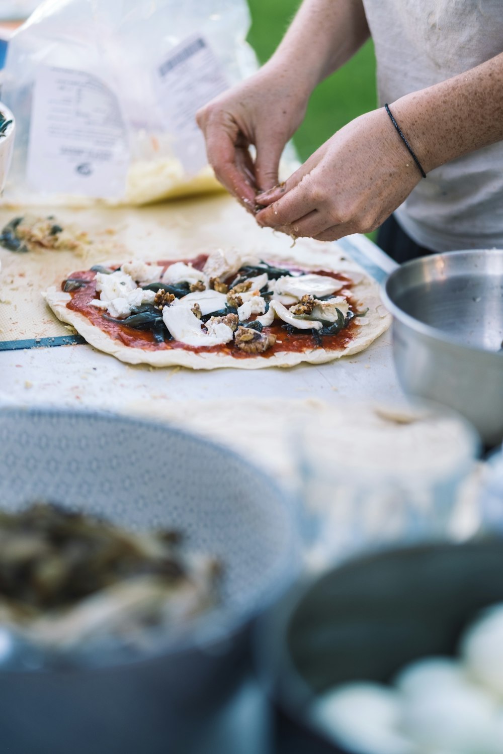 a person slicing a pizza