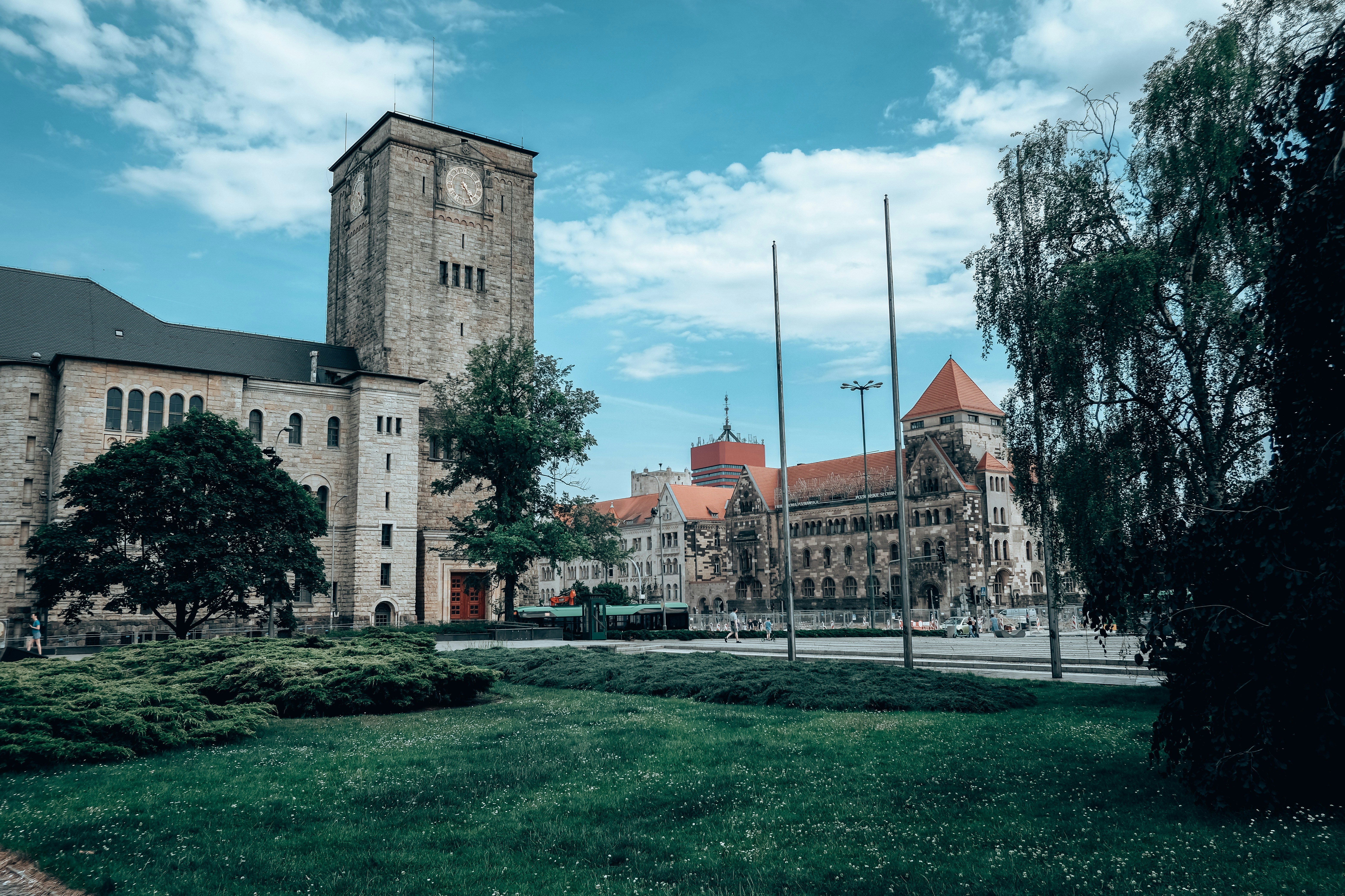 a large building with a clock tower with The Cloisters in the background