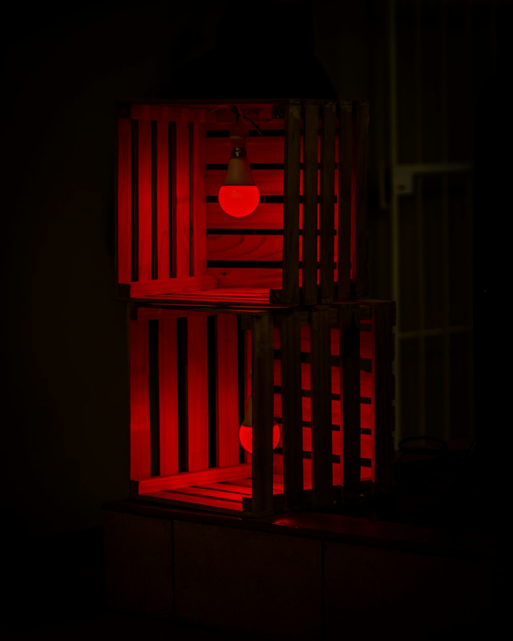 a red chair with a lamp on top