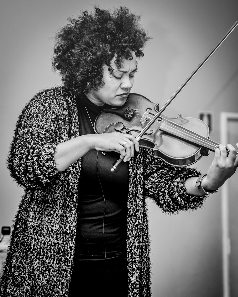 a woman playing a violin