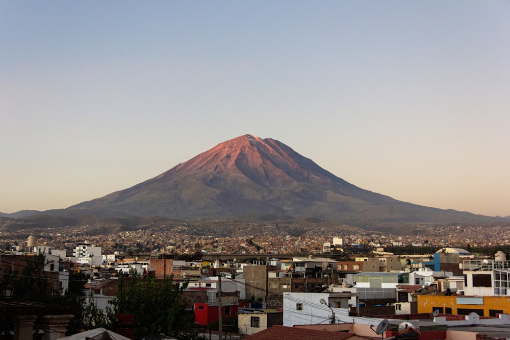 a large mountain behind a city